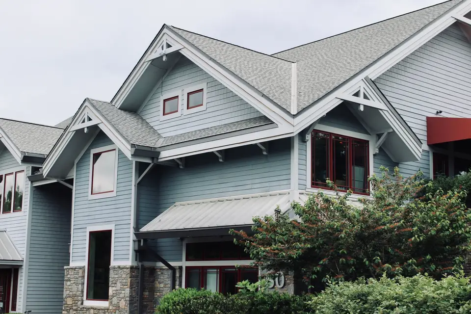 Blue-sided home with a grey shingle roof