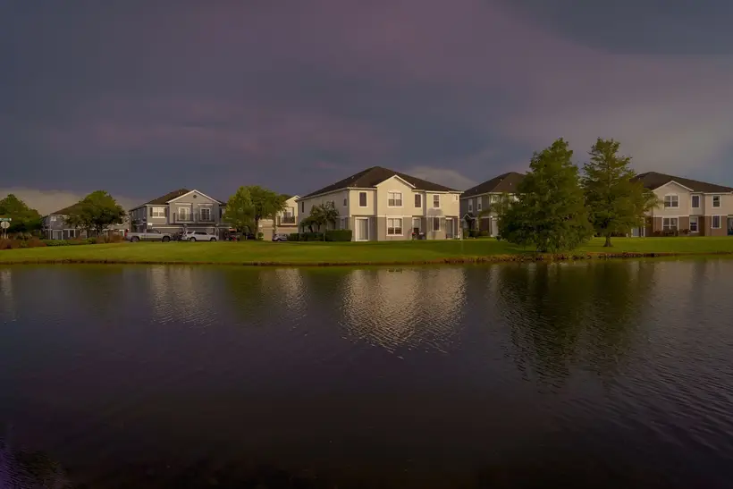 Lakefront homes under a stormy sky