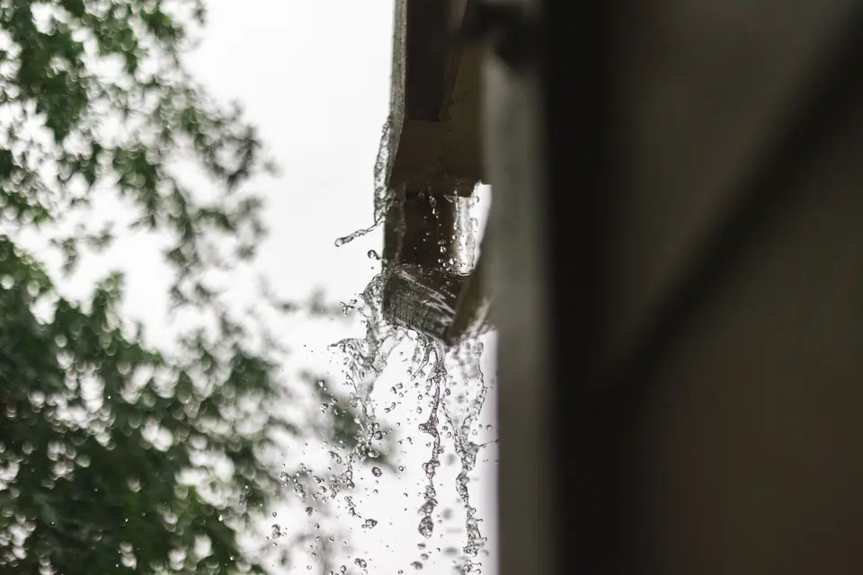 Rainwater spilling from a gutter