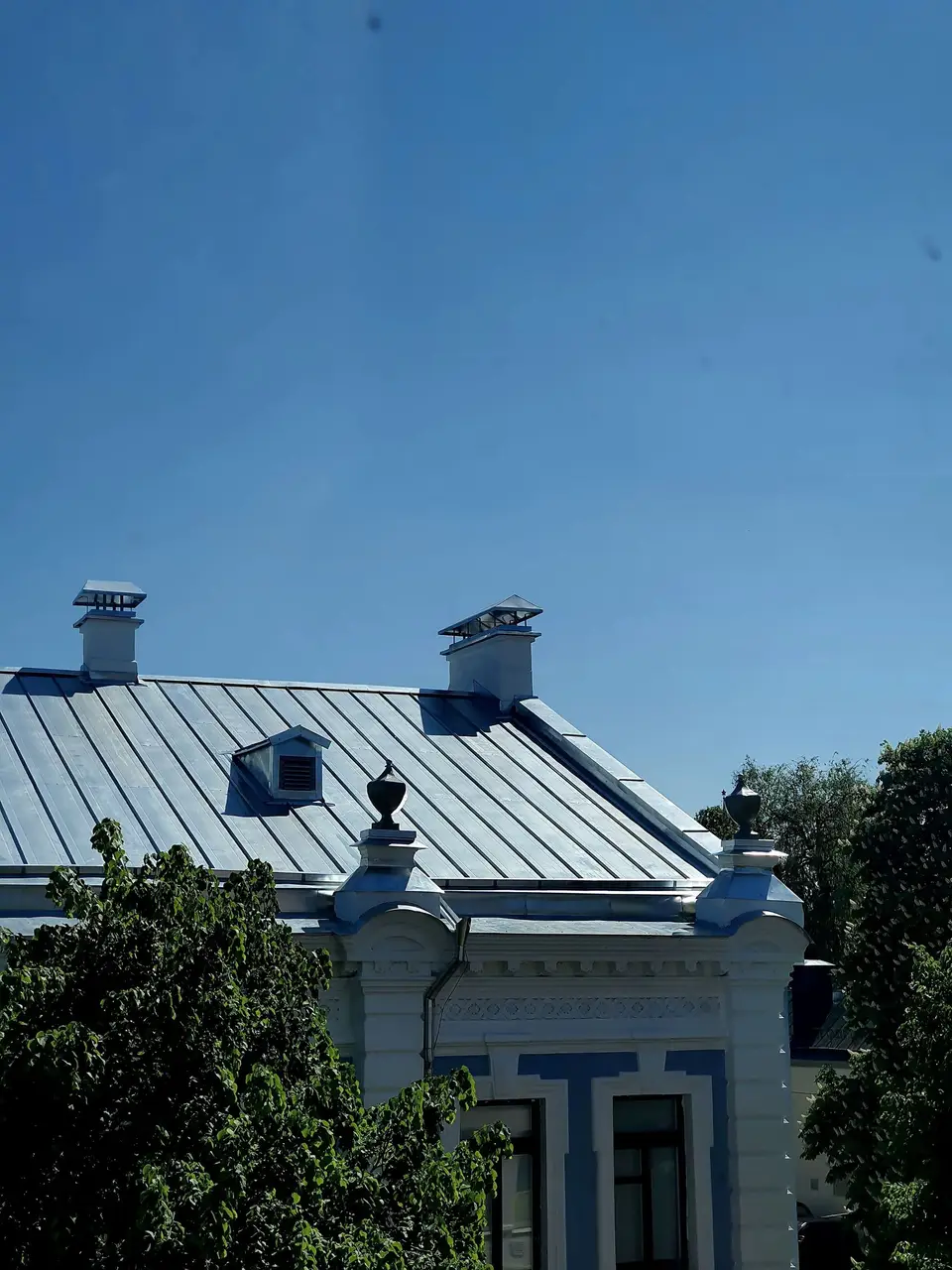 Grey metal roof on a two-story house