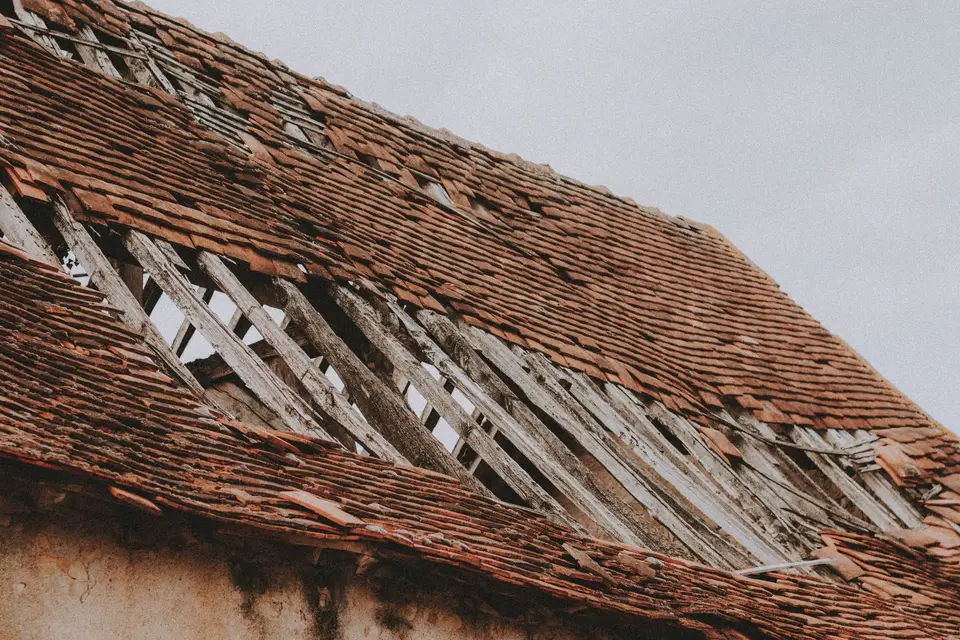 Roof with missing and broken shingles