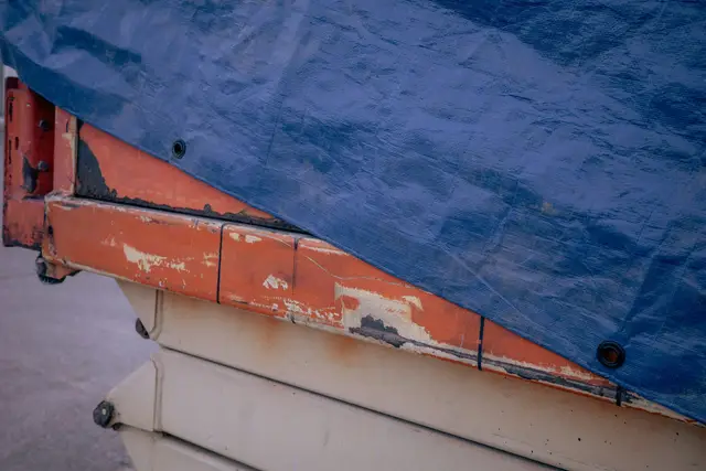 Blue tarp stretched over a structure