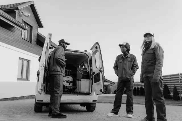 Crew talking beside an open work van